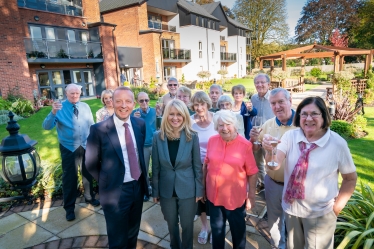 Residents join Esther to toast the development's second birthday